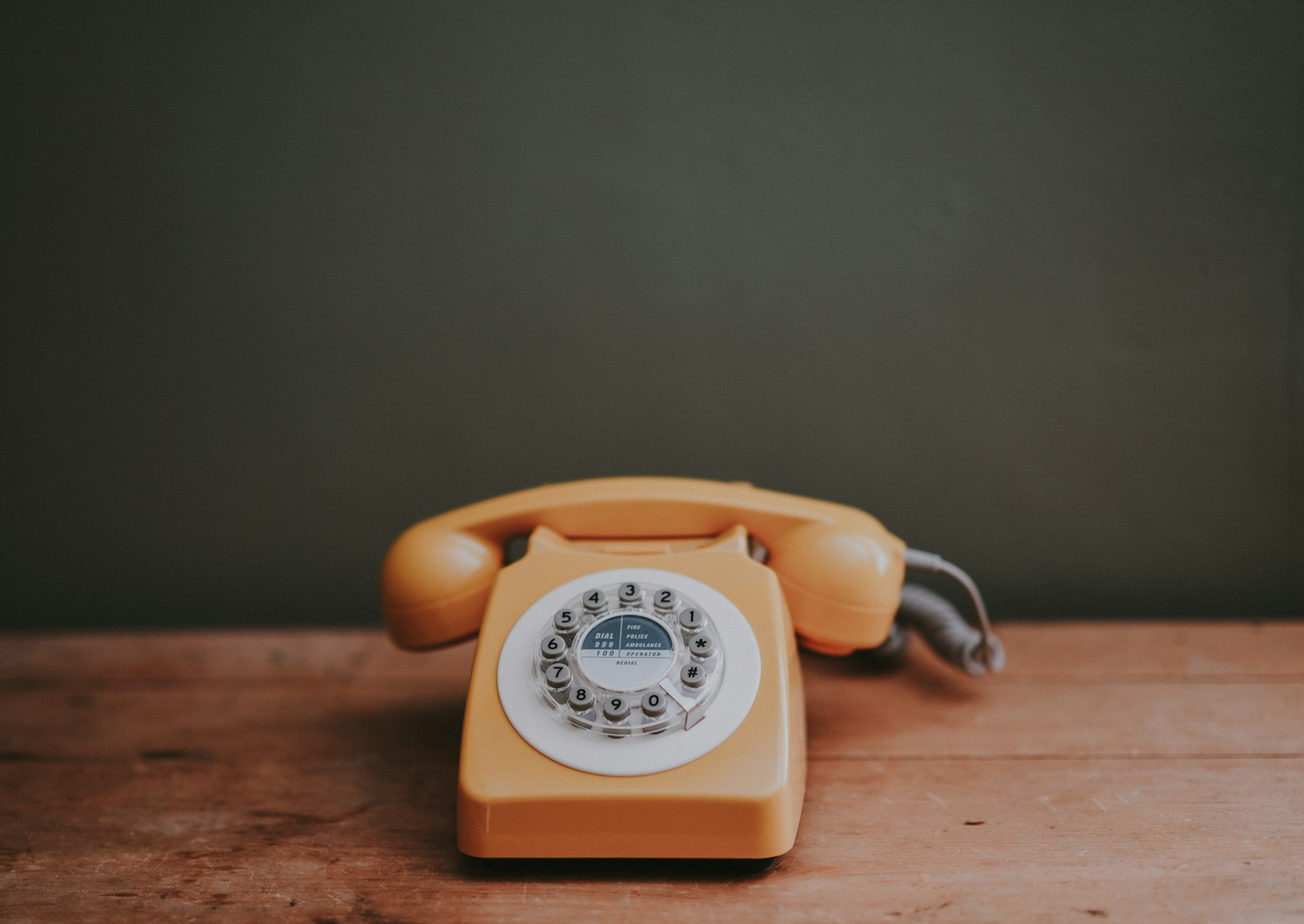 Oranje telefoon op tafel.